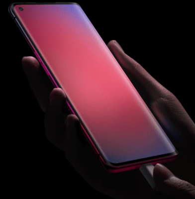 รูปภาพระยะใกล้แสดงมือที่กำลังเสียบสายชาร์จเข้ากับโทรศัพท์มือถือ OPPO ที่มีหน้าจอสีแดงอมม่วงสว่าง เพื่อเป็นภาพประกอบสำหรับบทความที่อธิบายว่า เทคโนโลยี SUPERVOOC คืออะไร