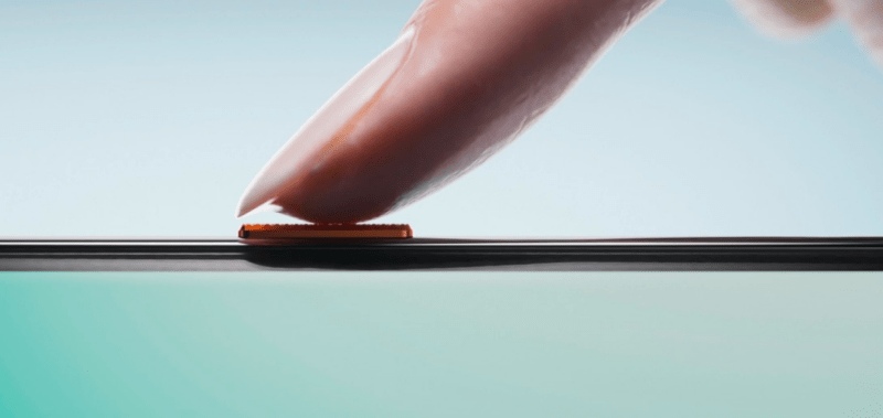 รีวิว TECNO Camon 40 Pro – ภาพโคลสอัพของนิ้วมือที่กำลังแตะปุ่มด้านข้างของโทรศัพท์มือถือ TECNO Camon 40 Pro ซึ่งน่าจะเป็นปุ่มเปิด/ปิดหรือเซนเซอร์สแกนลายนิ้วมือด้านข้าง เพื่อเน้นสเปกฟีเจอร์การใช้งาน